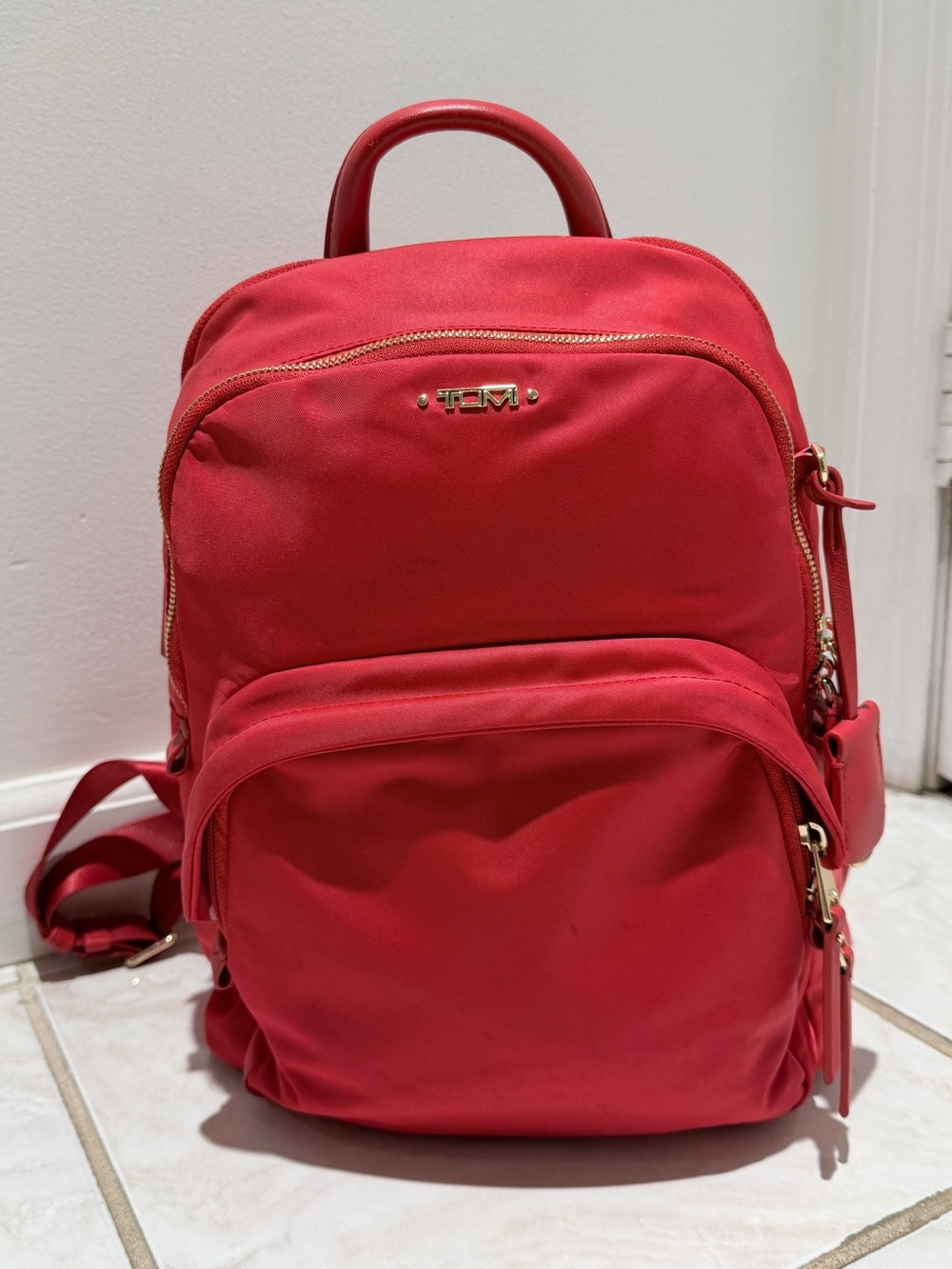 Tumi Voyageur Dori Backpack in a vibrant red/raspberry nylon finish.